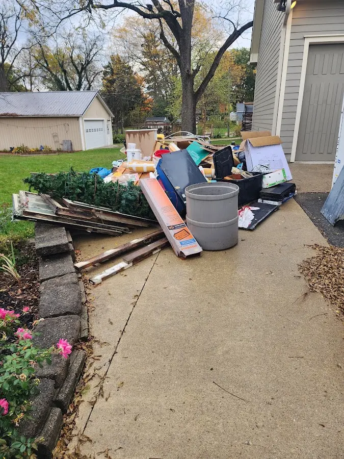 Dumpster being loaded with debris for Estate Cleanout Dumpster Rental in Dumfries